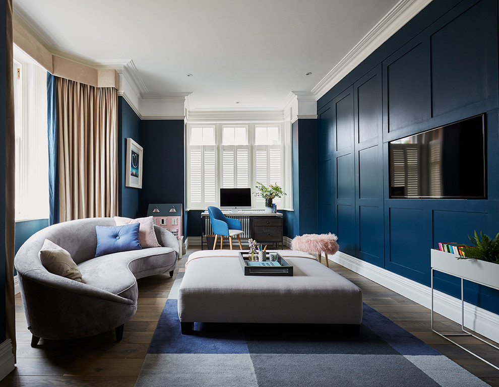 Inspiration for a transitional enclosed living room in Hertfordshire with blue walls, medium hardwood floors, no fireplace, a wall-mounted tv and brown floor.