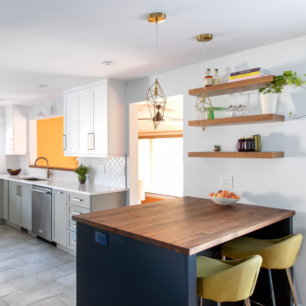 Kitchen - mid-sized transitional l-shaped ceramic tile kitchen idea in Ottawa with a double-bowl sink, shaker cabinets, quartz countertops, white backsplash, stainless steel appliances, a peninsula and white countertops