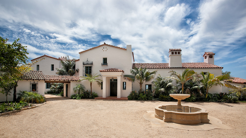 Expansive mediterranean two-storey stucco white exterior in Santa Barbara with a gable roof.