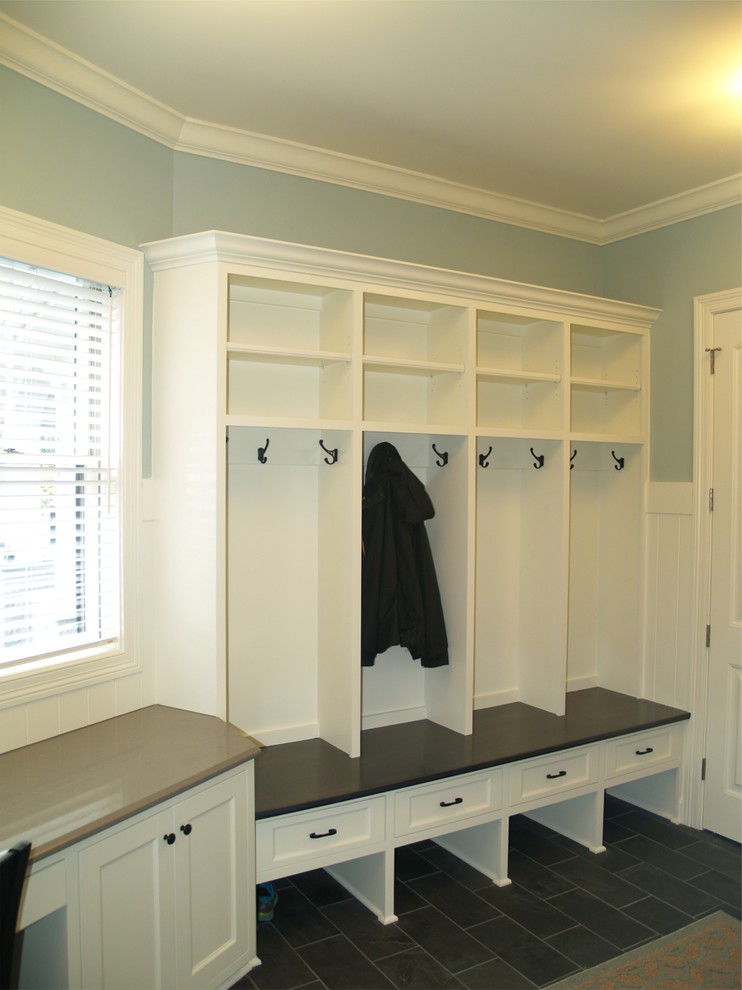 Inspiration for a large beach style mudroom in Milwaukee with blue walls and porcelain floors.
