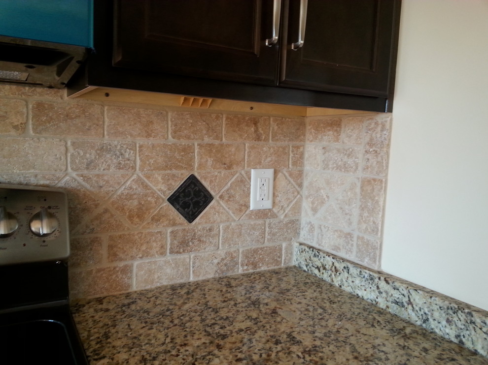 Minimalist kitchen photo in Atlanta with recessed-panel cabinets, dark wood cabinets, granite countertops, beige backsplash and stone tile backsplash