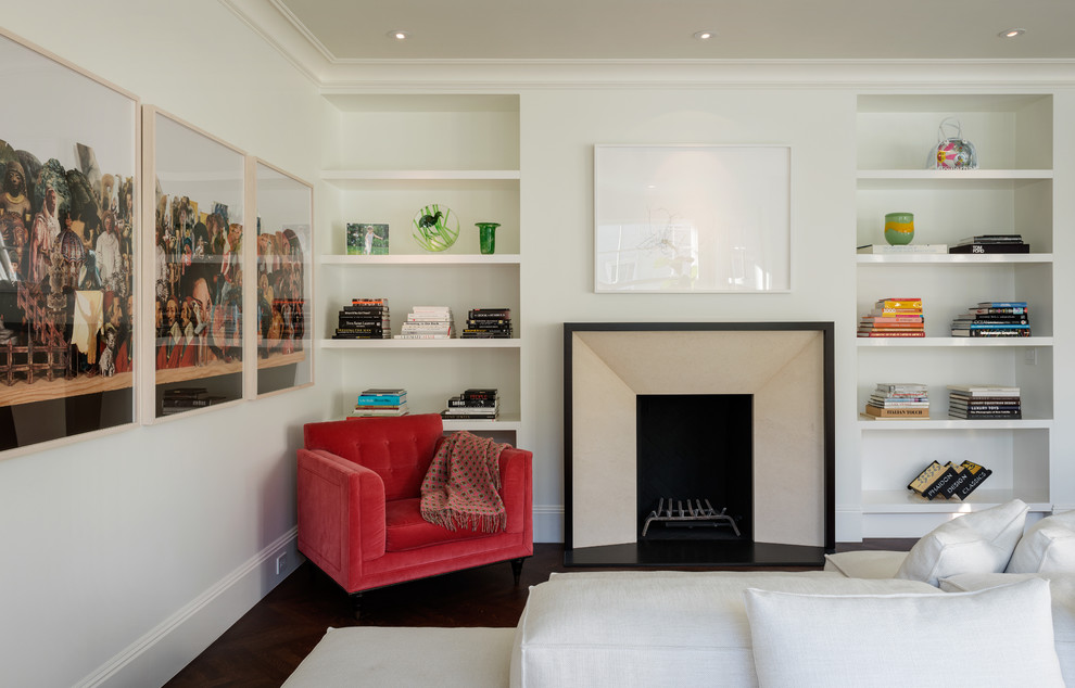 Photo of a contemporary living room in San Francisco with a library, white walls and a standard fireplace.