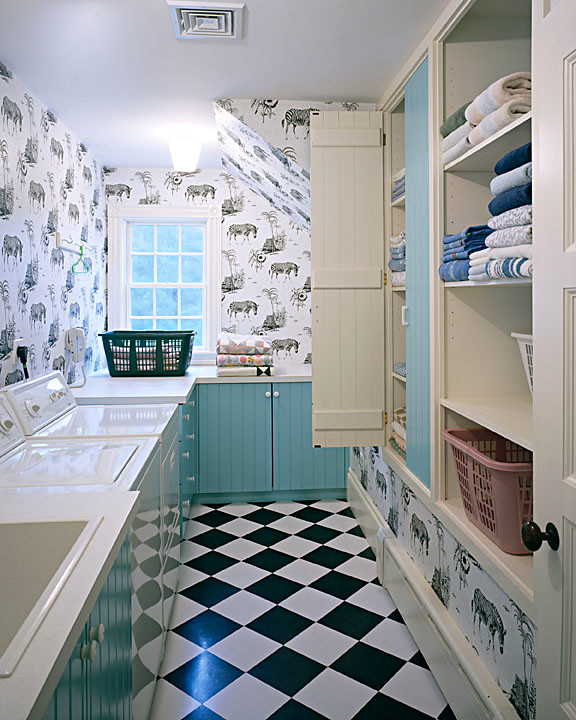 Inspiration for a classic utility room in Boston with blue cabinets, composite countertops, lino flooring and a side by side washer and dryer.