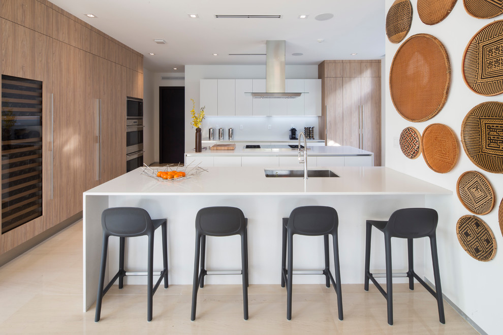 Inspiration for a contemporary kitchen in Miami with an undermount sink, flat-panel cabinets, white cabinets, white splashback, panelled appliances, beige floor and white benchtop.