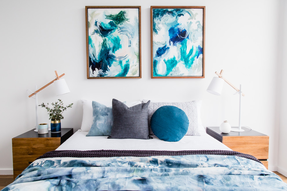 Mid-sized contemporary master bedroom in Melbourne with white walls and light hardwood floors.