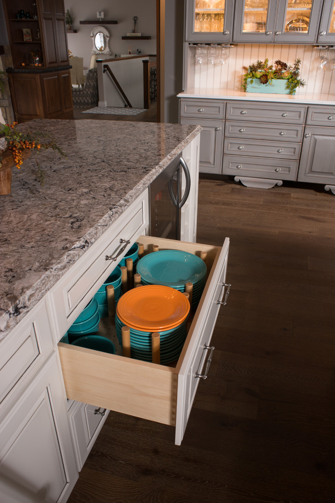 Design ideas for an expansive traditional galley eat-in kitchen in Other with a farmhouse sink, raised-panel cabinets, distressed cabinets, granite benchtops, grey splashback, stainless steel appliances, dark hardwood floors and multiple islands.