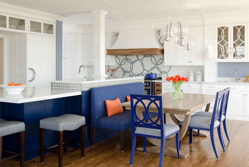 This is an example of a large contemporary eat-in kitchen in Portland Maine with glass-front cabinets, a single-bowl sink, white cabinets, quartz benchtops, mosaic tile splashback and medium hardwood floors.