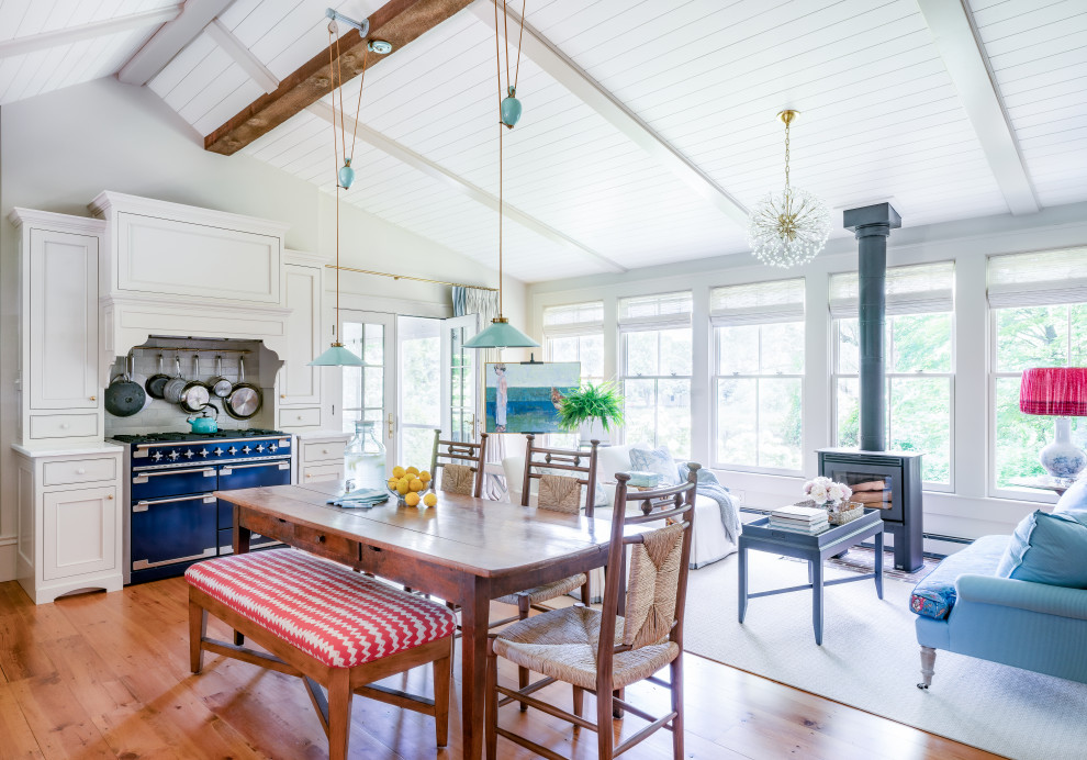 Inspiration for a transitional vaulted ceiling open concept kitchen remodel in Boston with a farmhouse sink, recessed-panel cabinets, beige cabinets, marble countertops, colored appliances, no island and white countertops