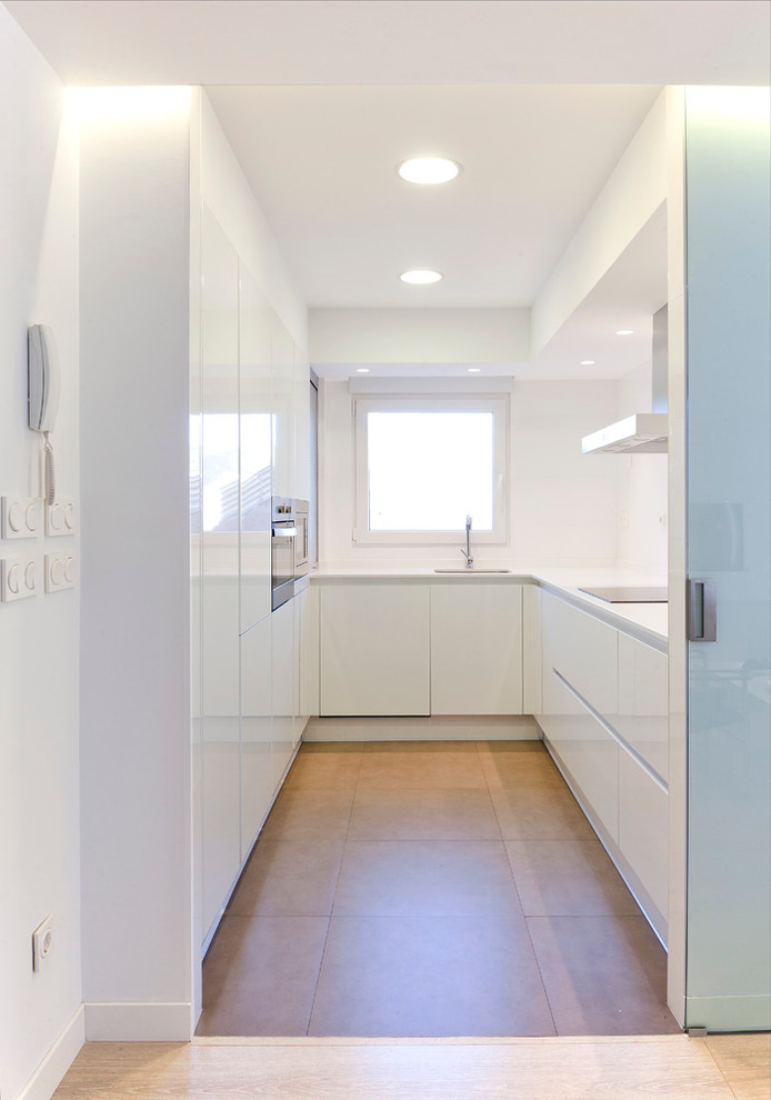 Photo of a contemporary u-shaped separate kitchen in Other with flat-panel cabinets, white cabinets and ceramic floors.