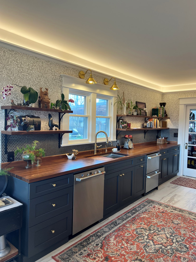 Design ideas for a medium sized classic galley kitchen/diner in Seattle with shaker cabinets, blue cabinets and an island.