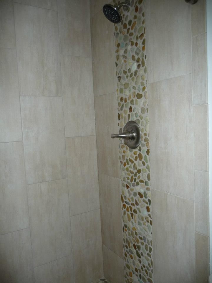 Alcove shower - mid-sized transitional master beige tile and porcelain tile pebble tile floor alcove shower idea in Milwaukee with white walls