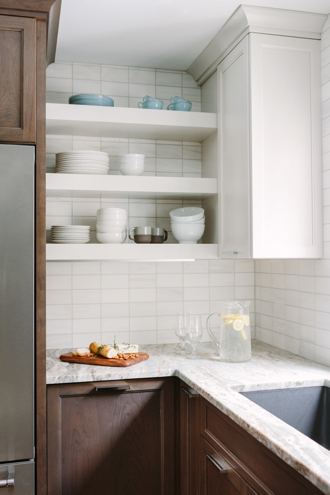 Example of a transitional u-shaped dark wood floor and brown floor eat-in kitchen design in Chicago with an undermount sink, shaker cabinets, dark wood cabinets, marble countertops, beige backsplash, stainless steel appliances, an island and beige countertops