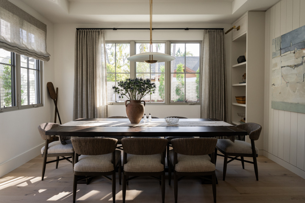 Photo of a transitional dining room in Orange County with light hardwood floors, beige walls, beige floor, recessed and planked wall panelling.