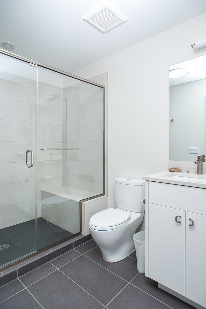 Photo of a small asian 3/4 bathroom in Detroit with a corner shower, multi-coloured tile, a drop-in sink, flat-panel cabinets, white cabinets, marble benchtops, a one-piece toilet, white walls and ceramic floors.