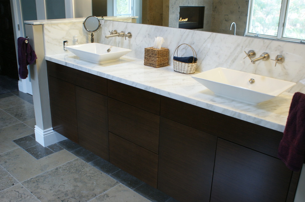 Inspiration for a large modern master bathroom in San Diego with flat-panel cabinets, dark wood cabinets, a freestanding tub, a corner shower, a one-piece toilet, beige tile and beige walls.