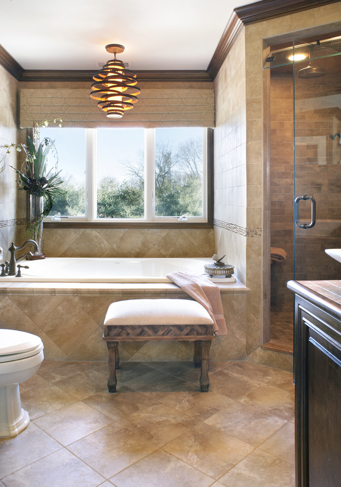 Photo of a mid-sized master bathroom in Newark with a vessel sink, furniture-like cabinets, dark wood cabinets, an alcove tub, a two-piece toilet, brown tile, porcelain tile, beige walls, porcelain floors and a corner shower.