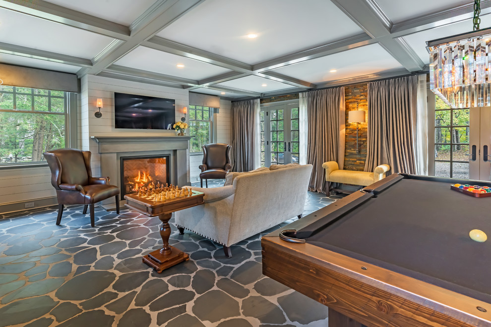 Design ideas for a traditional open concept family room in New York with a game room, white walls, a standard fireplace, a wall-mounted tv and grey floor.