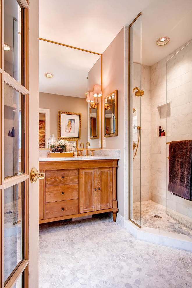 This is an example of a traditional bathroom in Denver with medium wood cabinets, white tile, beige walls, mosaic tile floors and shaker cabinets.