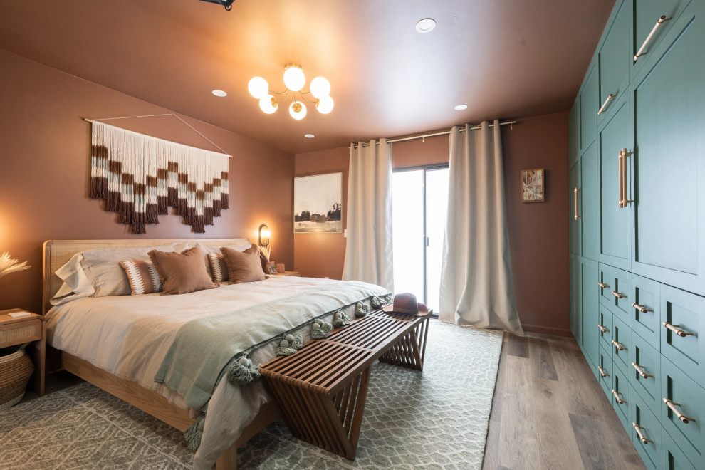Inspiration for a mid-sized transitional master medium tone wood floor and brown floor bedroom remodel in Los Angeles with orange walls