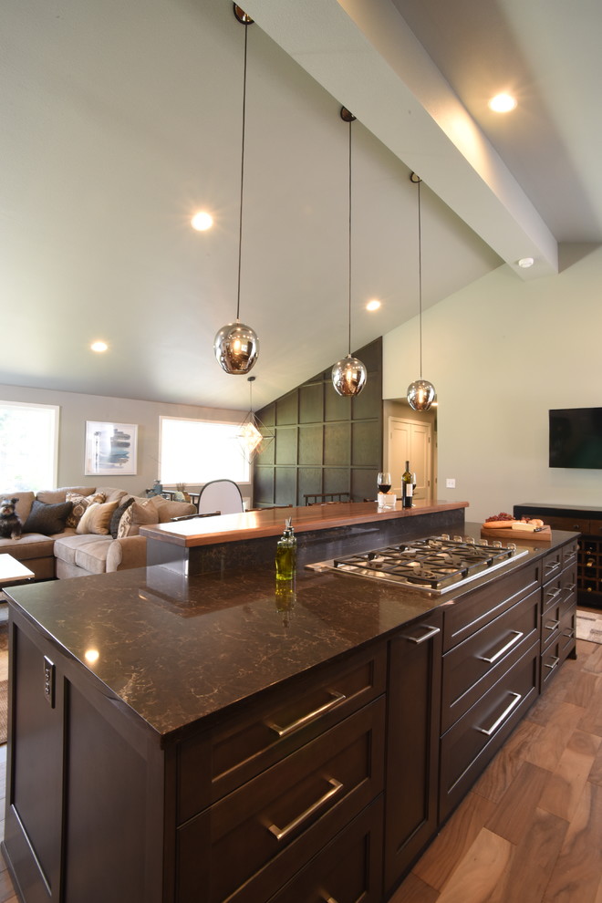 Kitchen - transitional galley medium tone wood floor kitchen idea in Seattle with shaker cabinets, dark wood cabinets, quartzite countertops and two islands