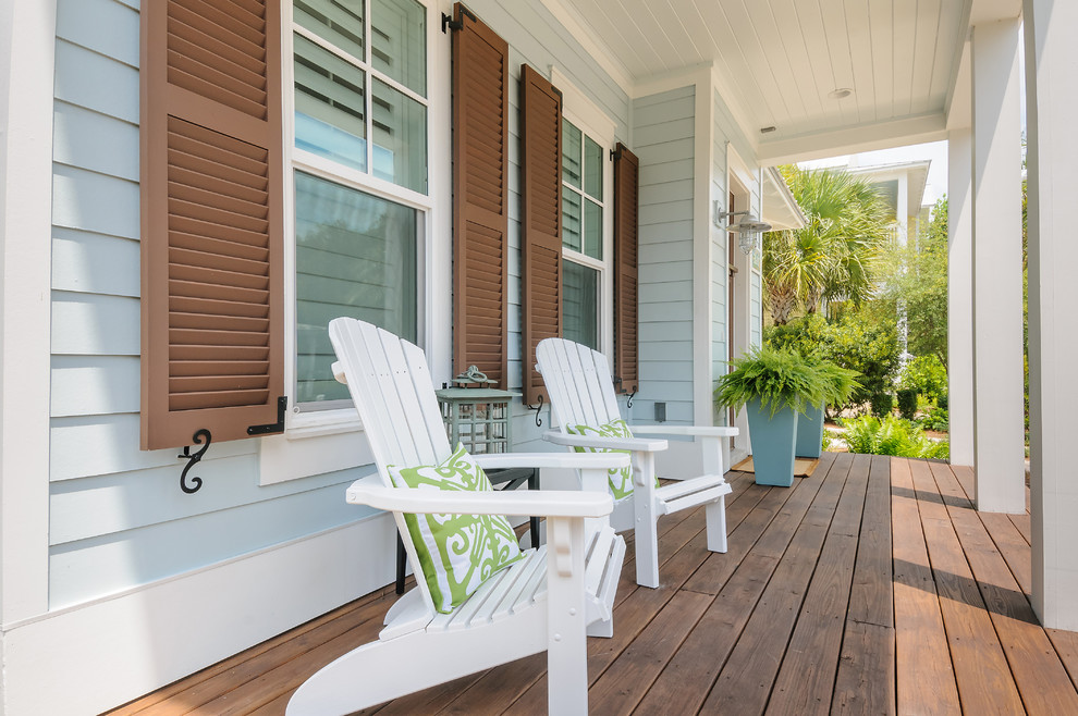 Photo of a small beach style front yard verandah in Jacksonville with decking and a roof extension.