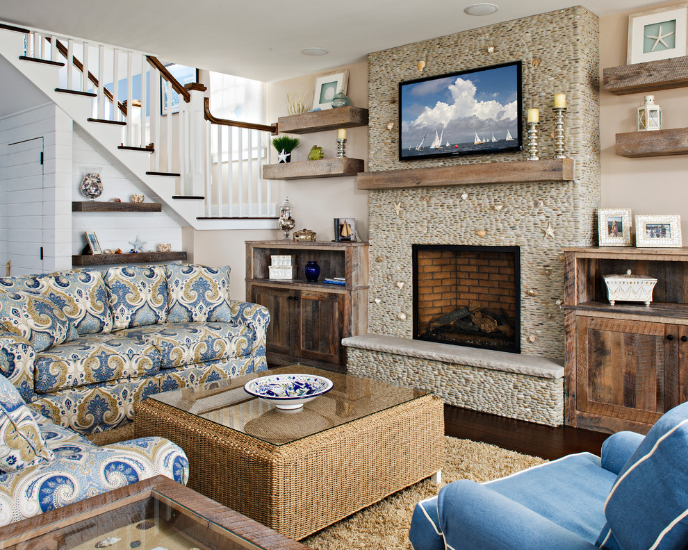 Photo of a beach style living room in New York with beige walls, a standard fireplace and a wall-mounted tv.