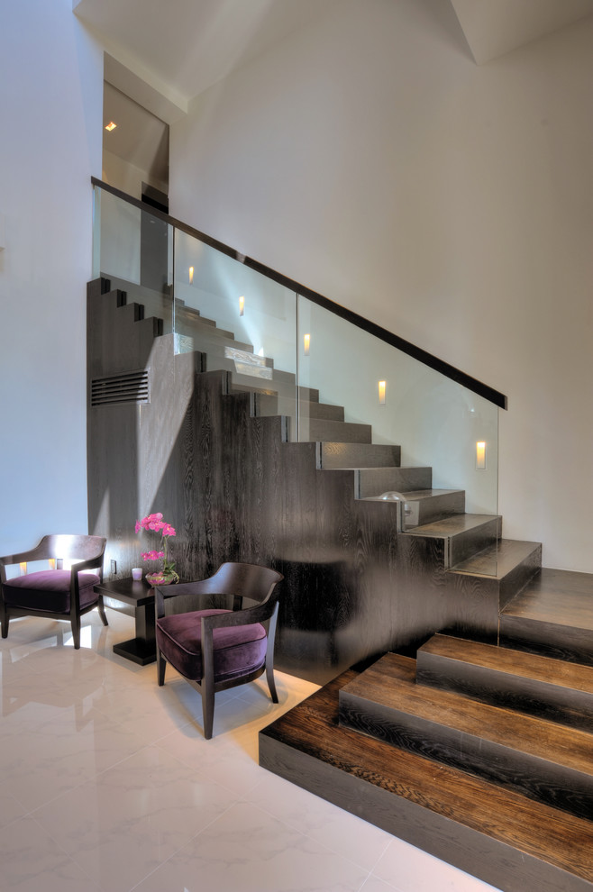 This is an example of a contemporary wood l-shaped staircase in Miami with wood risers.