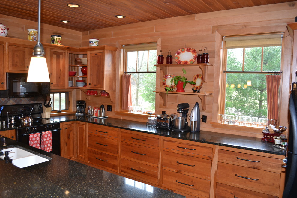Example of a mid-sized mountain style l-shaped dark wood floor enclosed kitchen design with medium tone wood cabinets, black appliances and no island