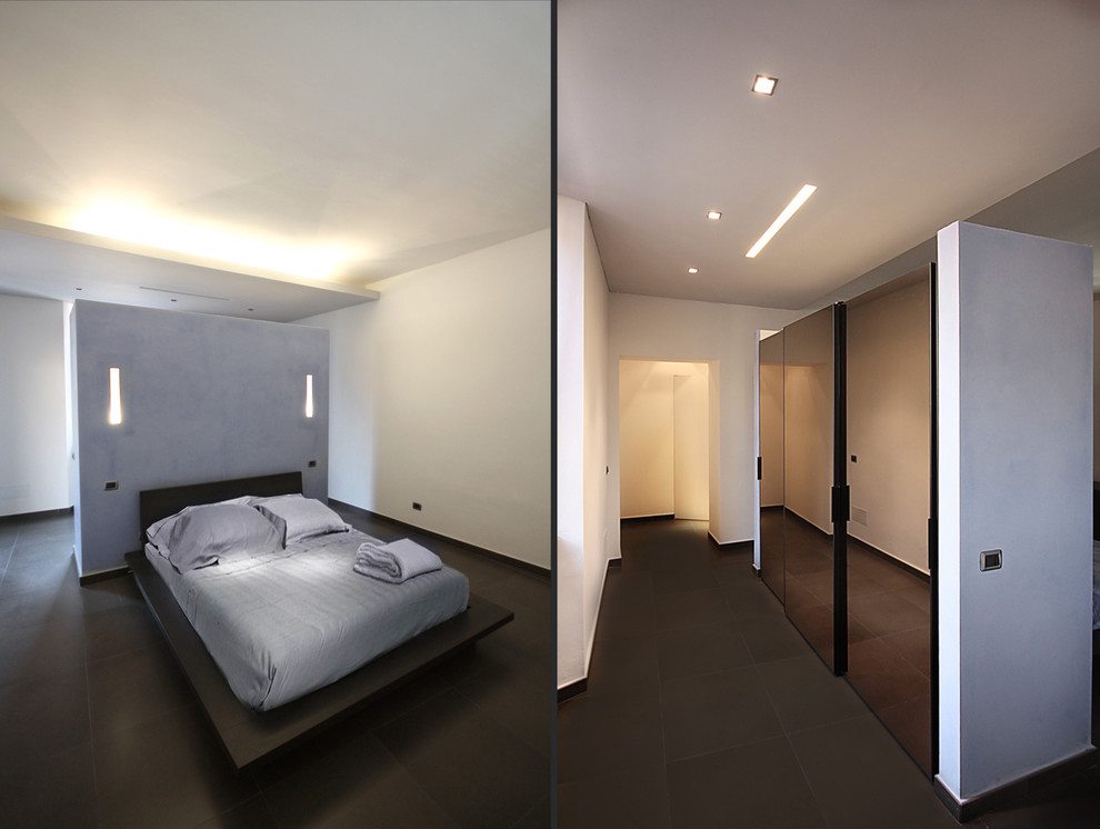 This is an example of a mid-sized contemporary master bedroom in Turin with white walls and porcelain floors.