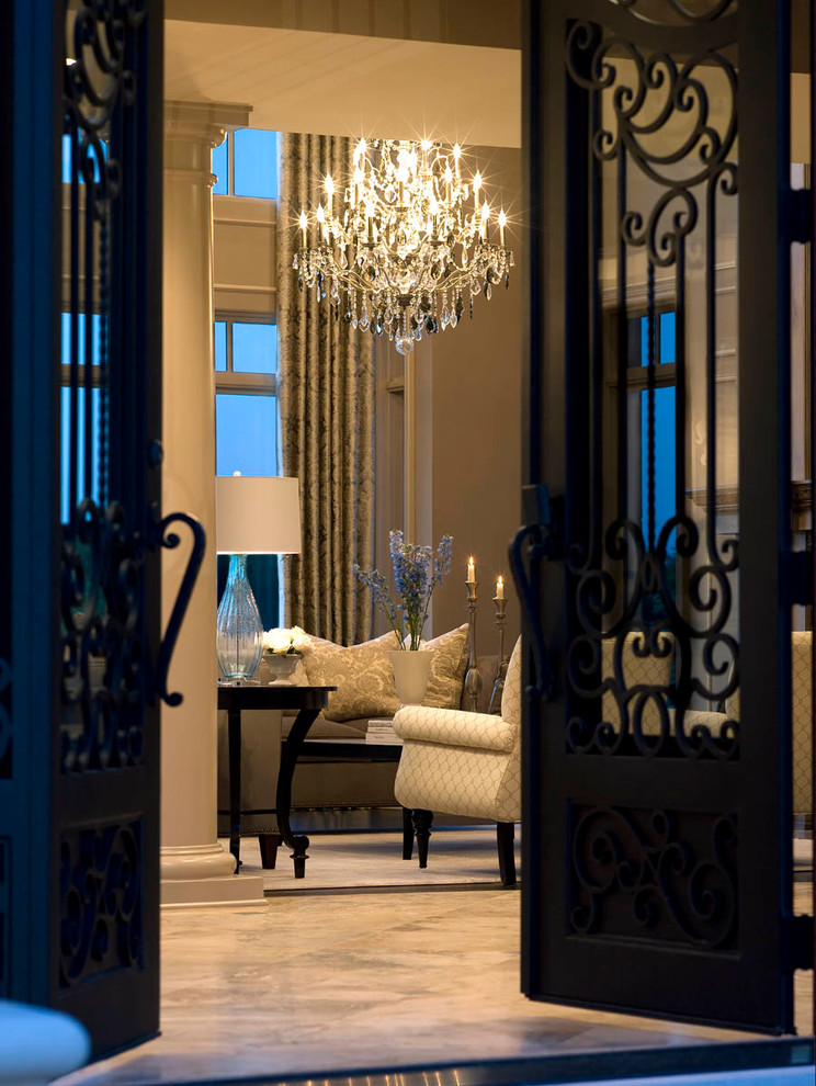 Photo of an expansive transitional foyer in Detroit with beige walls, travertine floors, a double front door and a black front door.