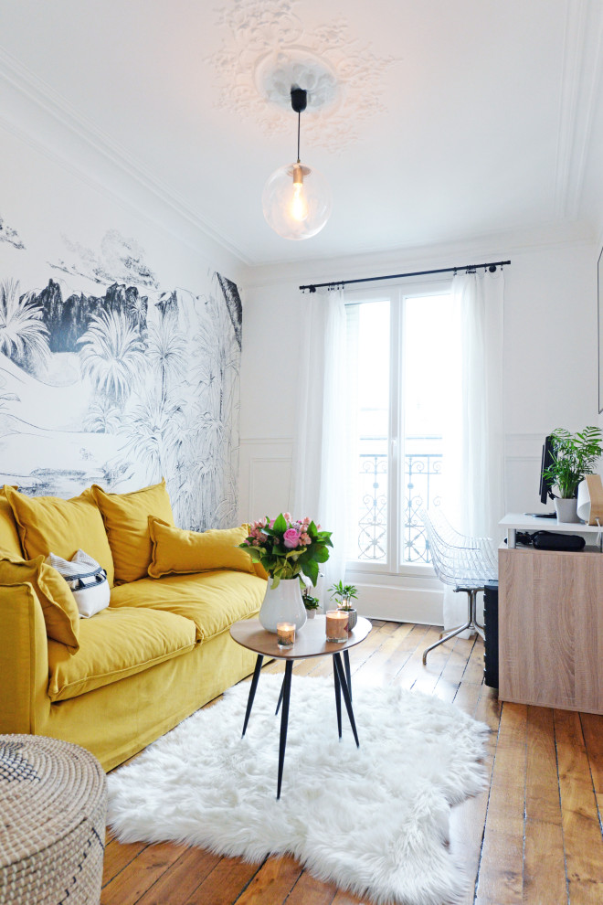 Mid-sized transitional living room in Paris with white walls, medium hardwood floors and brown floor.