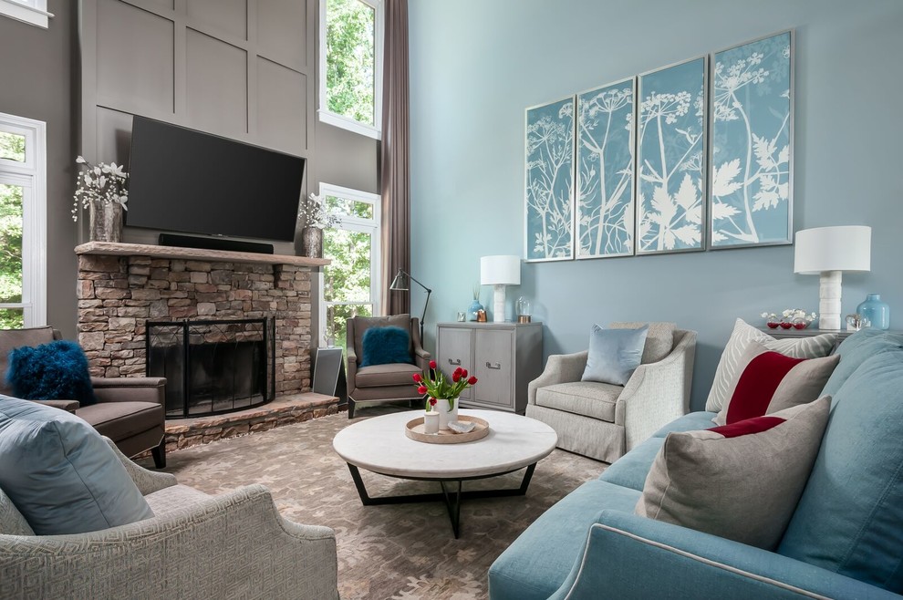 This is an example of a beach style family room in Atlanta with blue walls, a standard fireplace, a stone fireplace surround and a wall-mounted tv.