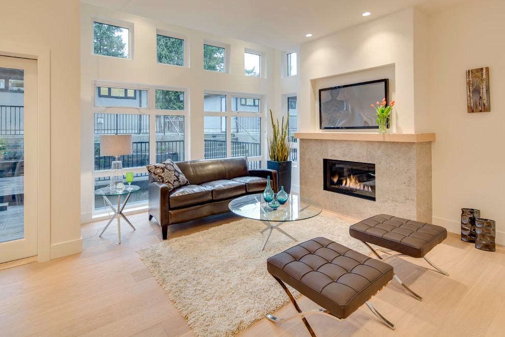 Design ideas for a small contemporary living room in Vancouver with white walls, light hardwood floors, a tile fireplace surround and a wall-mounted tv.