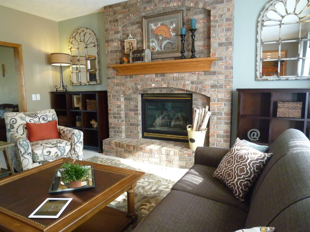 Design ideas for a mid-sized transitional enclosed family room in Omaha with blue walls, carpet, a standard fireplace and a brick fireplace surround.