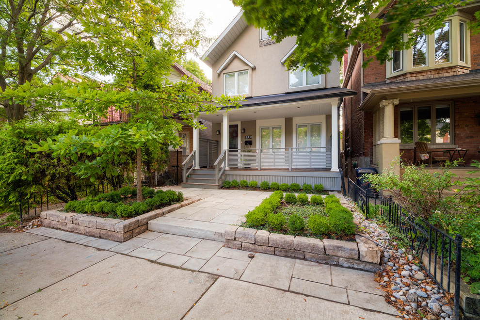 Small modern front yard partial sun garden in Toronto with a garden path and natural stone pavers.
