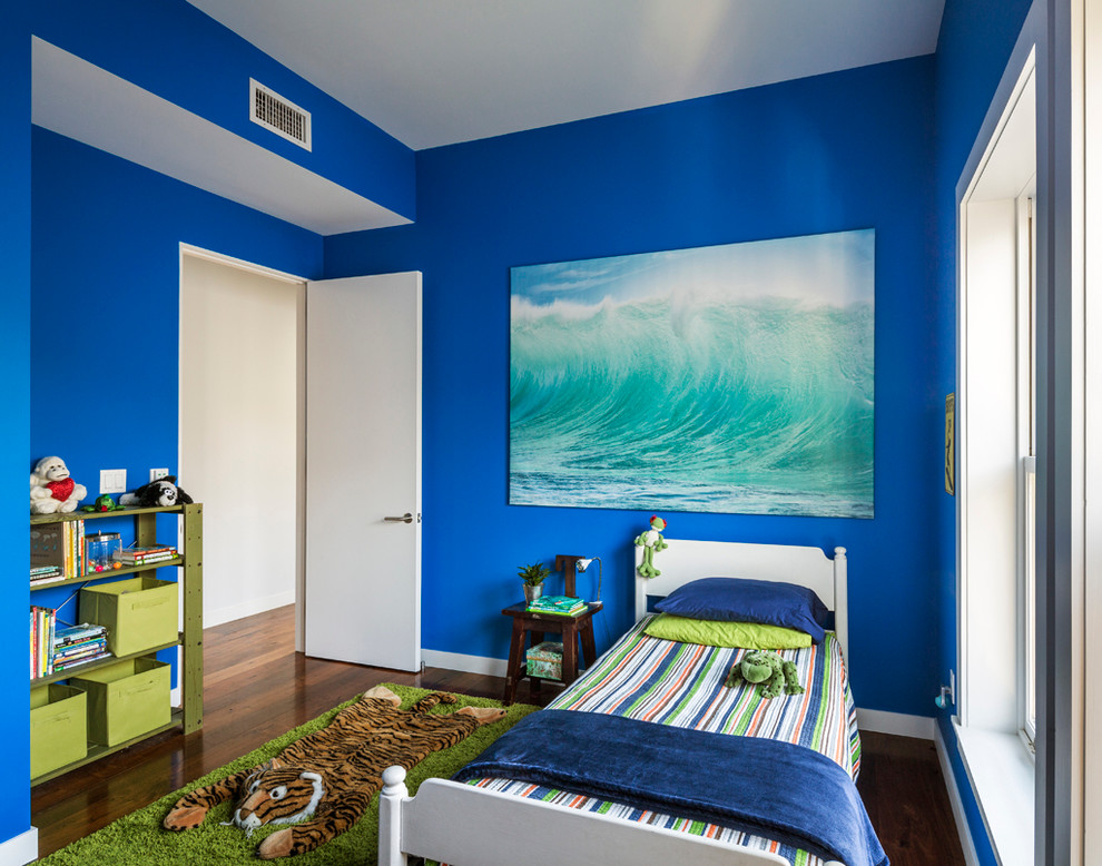 Design ideas for a contemporary kids' bedroom for boys in New York with blue walls and dark hardwood floors.