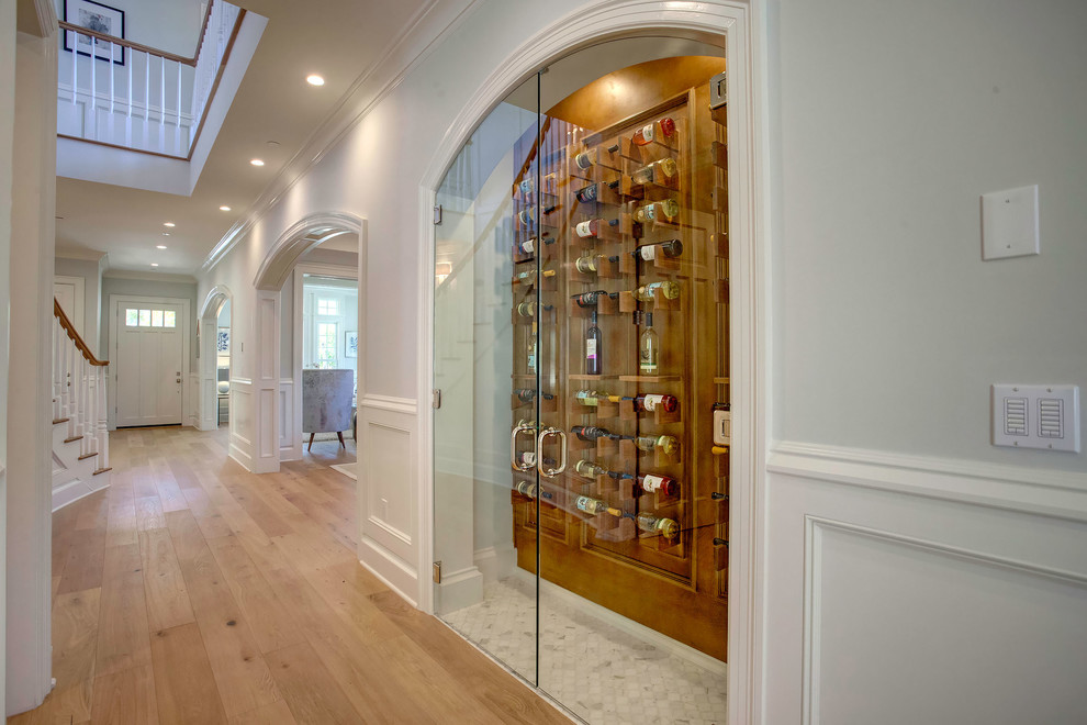 Inspiration for a small traditional wine cellar in Los Angeles with display racks, white floor and marble floors.