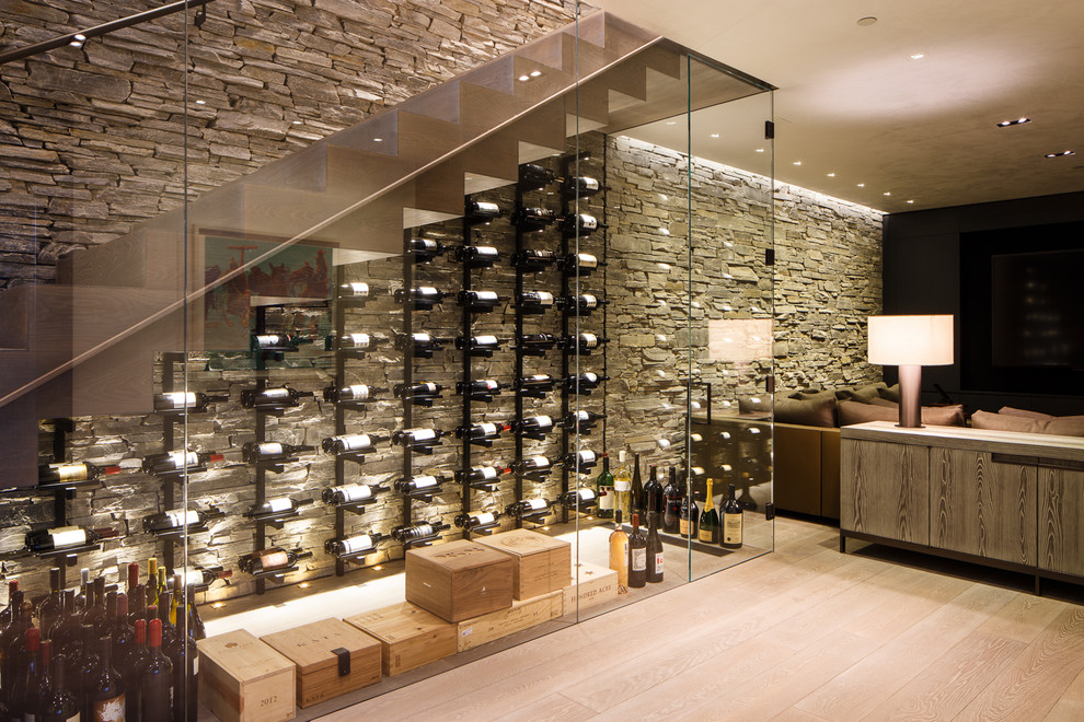 Design ideas for a mid-sized contemporary wine cellar in Denver with display racks, light hardwood floors and beige floor.