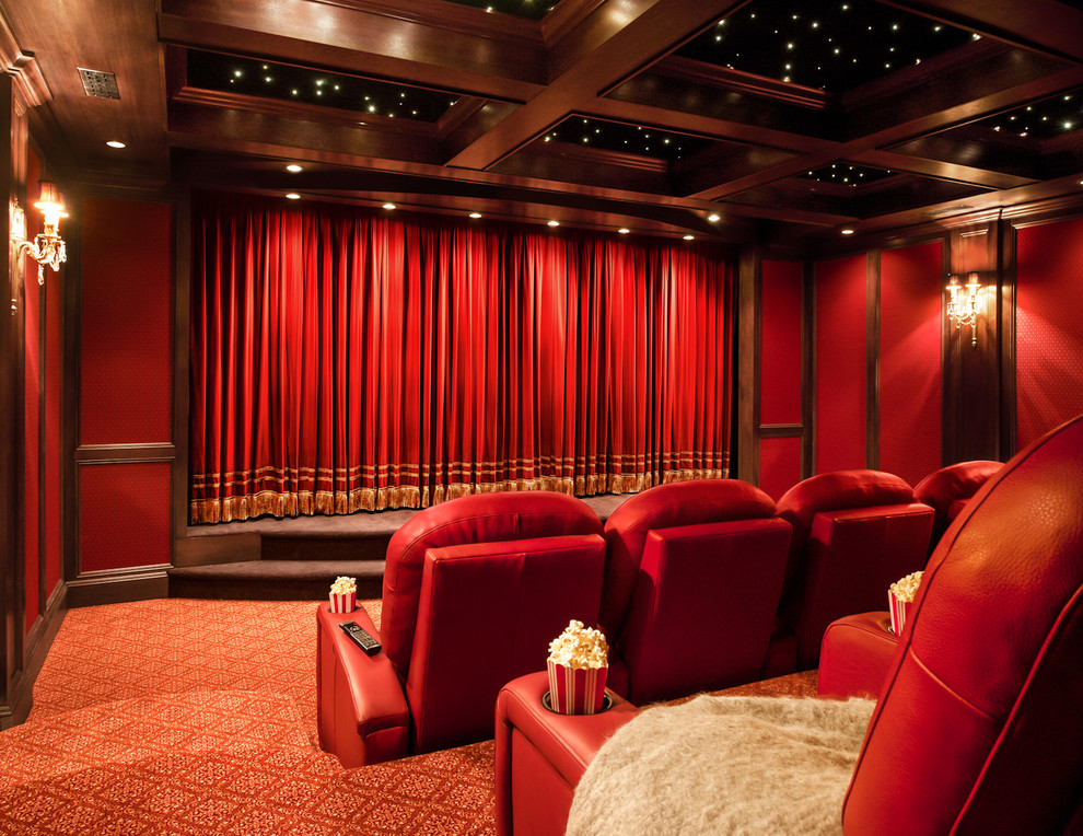 Expansive traditional enclosed home theatre in New York with red walls, carpet and a projector screen.