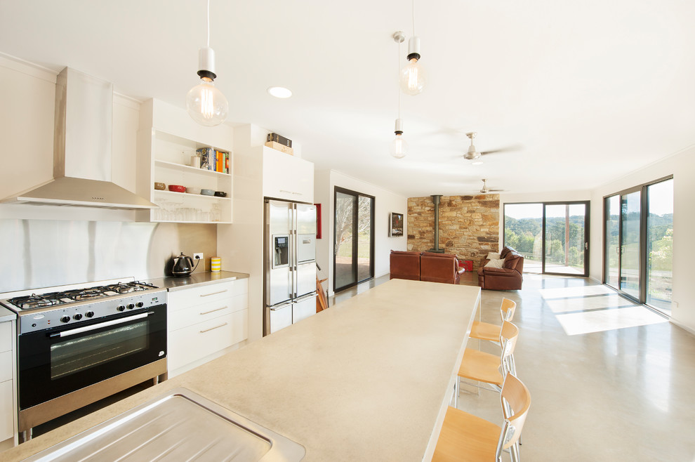 Mid-sized contemporary u-shaped open plan kitchen in Adelaide with concrete benchtops, concrete floors, with island, a double-bowl sink, stainless steel appliances and grey floor.