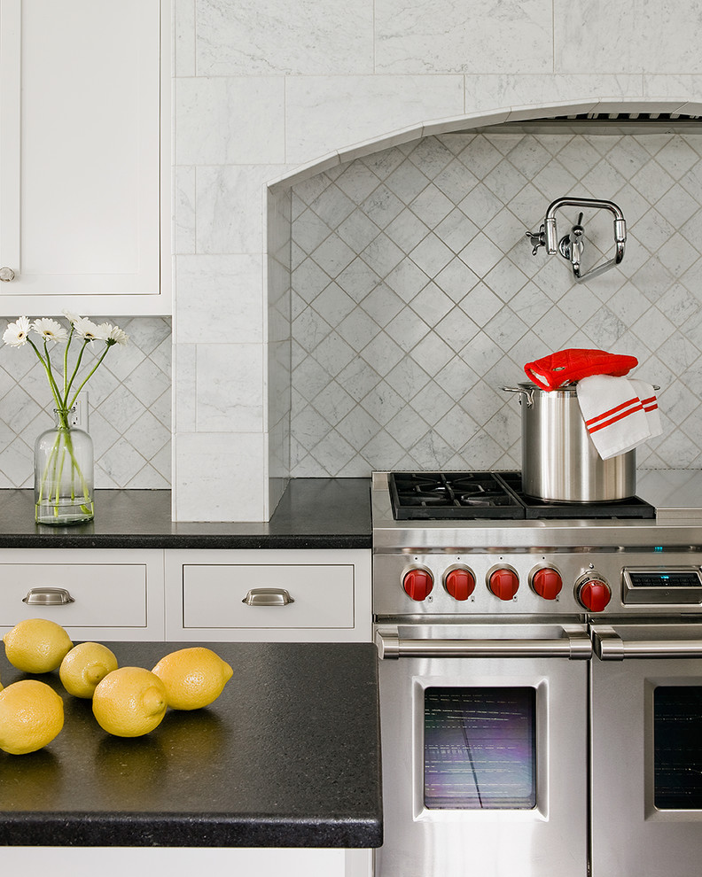 Inspiration for a large transitional u-shaped porcelain tile eat-in kitchen remodel in Boston with flat-panel cabinets, gray cabinets, gray backsplash, stainless steel appliances, an island, a farmhouse sink, granite countertops and marble backsplash