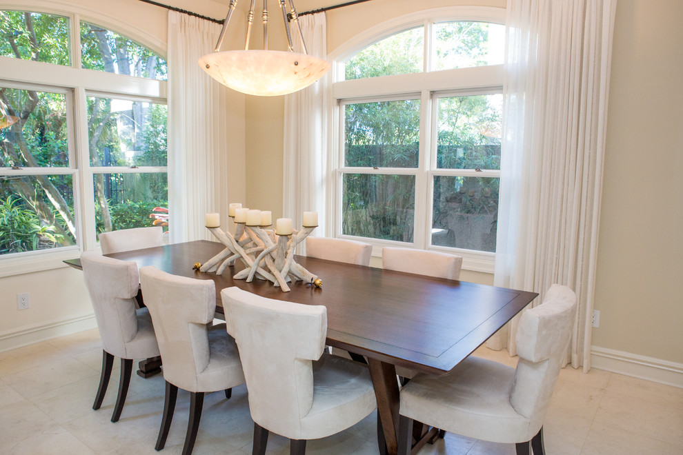 Photo of a transitional dining room in Tampa with beige walls.