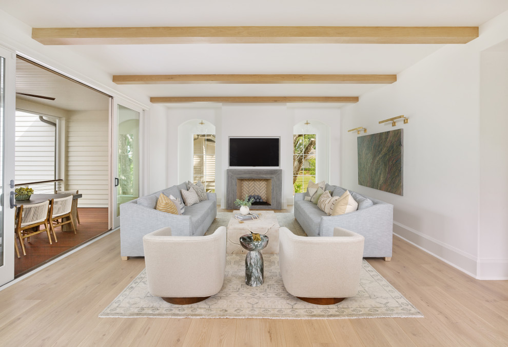 Inspiration for a transitional open concept light wood floor, brown floor and exposed beam living room remodel in Charleston with white walls, a standard fireplace, a stone fireplace and a wall-mounted tv