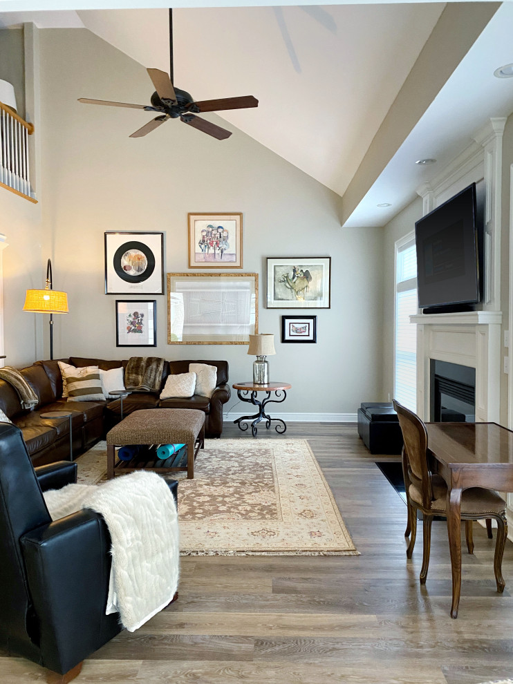 Example of a mid-sized trendy open concept brown floor and vinyl floor living room design in Other