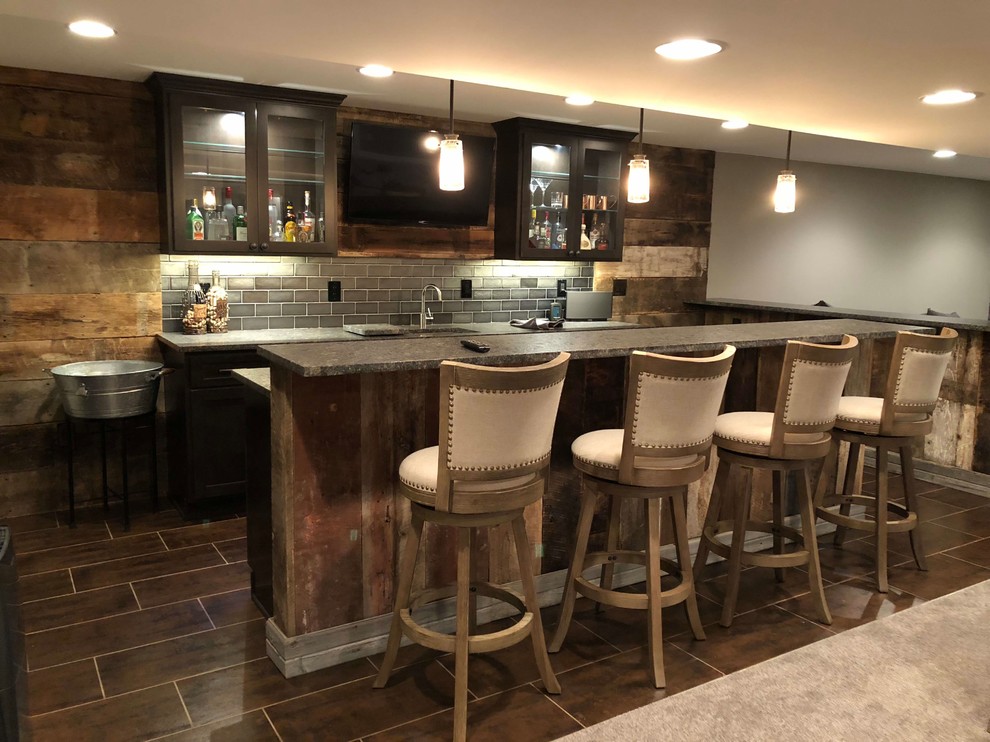 This is an example of a mid-sized country single-wall seated home bar in Detroit with glass-front cabinets and wood benchtops.