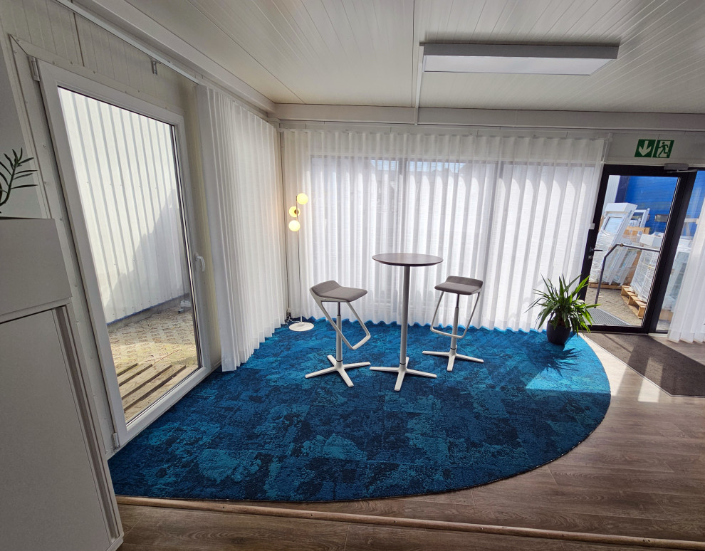 Mid-sized beach style study room in Other with white walls, carpet and blue floor.