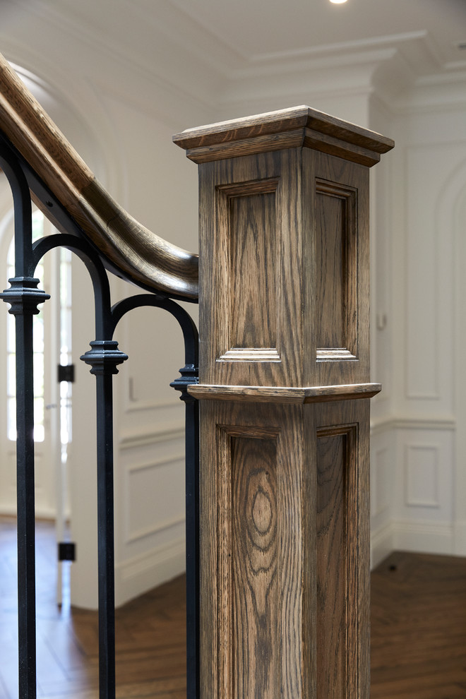 This is an example of an expansive traditional wood curved staircase in Melbourne with wood risers and wood railing.