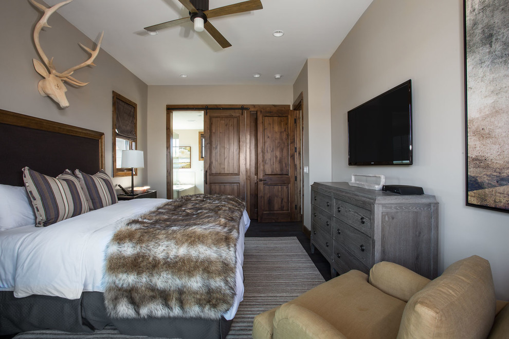 Mountain style dark wood floor bedroom photo in Salt Lake City with beige walls