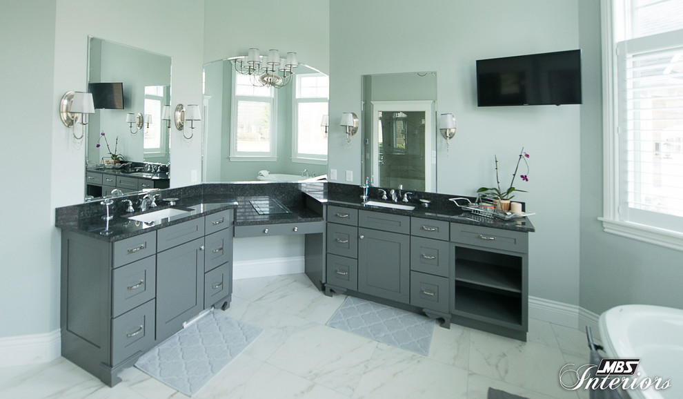 This is an example of an expansive traditional master bathroom in Other with shaker cabinets, grey cabinets, a freestanding tub, a one-piece toilet, green walls, an undermount sink, granite benchtops, marble floors and white floor.