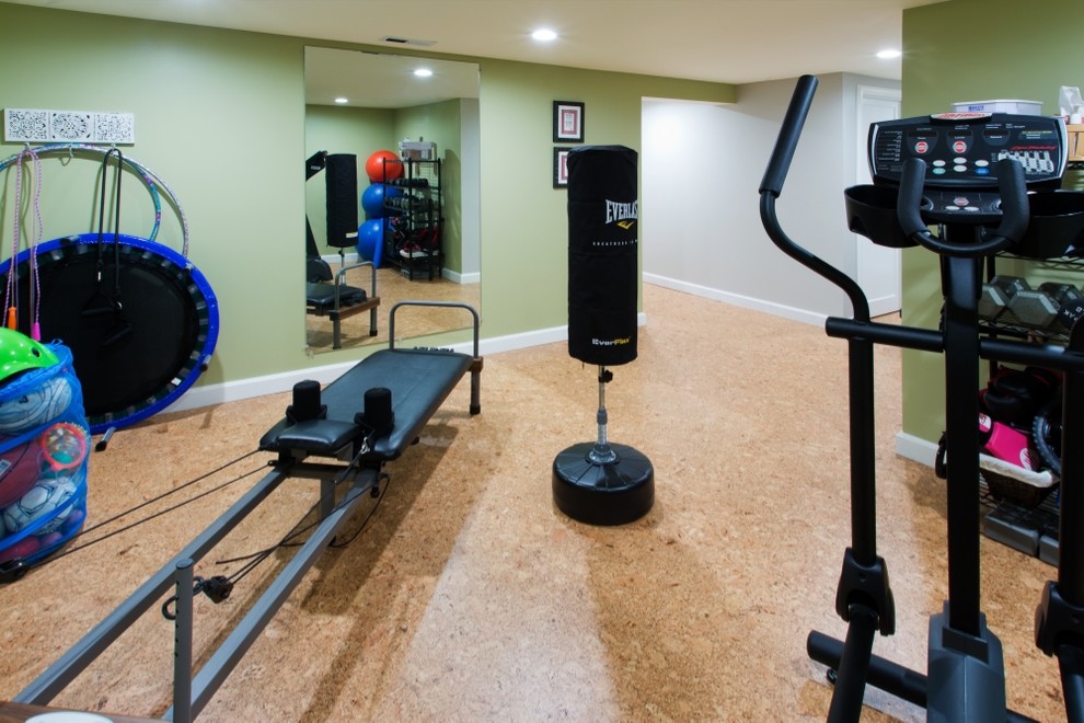 This is an example of a mid-sized transitional home weight room in Portland with green walls, cork floors and brown floor.